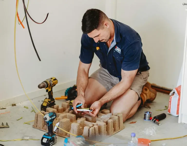 Electrician installing and preparing electrical cables on the floor, showing on-site electrical work.