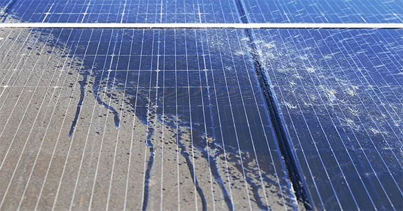 Close-up of dirty solar panels with grime and water marks reducing efficiency.