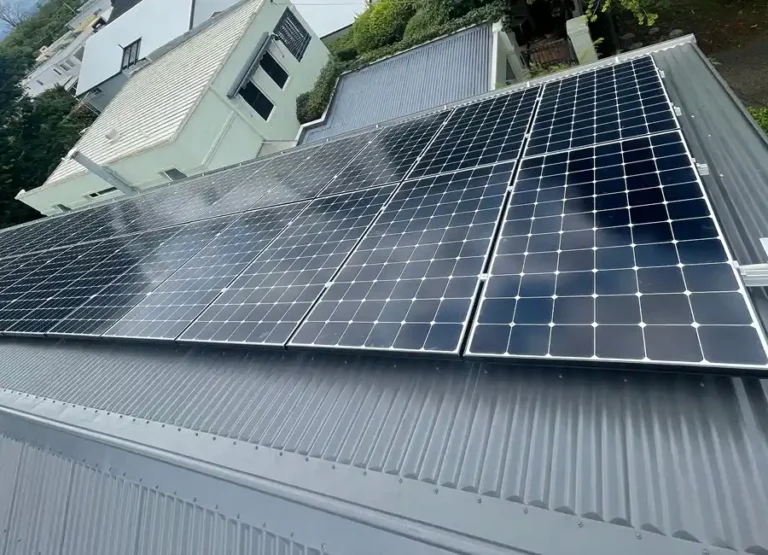Solar panel system mounted on a residential metal roof capturing sunlight for energy.