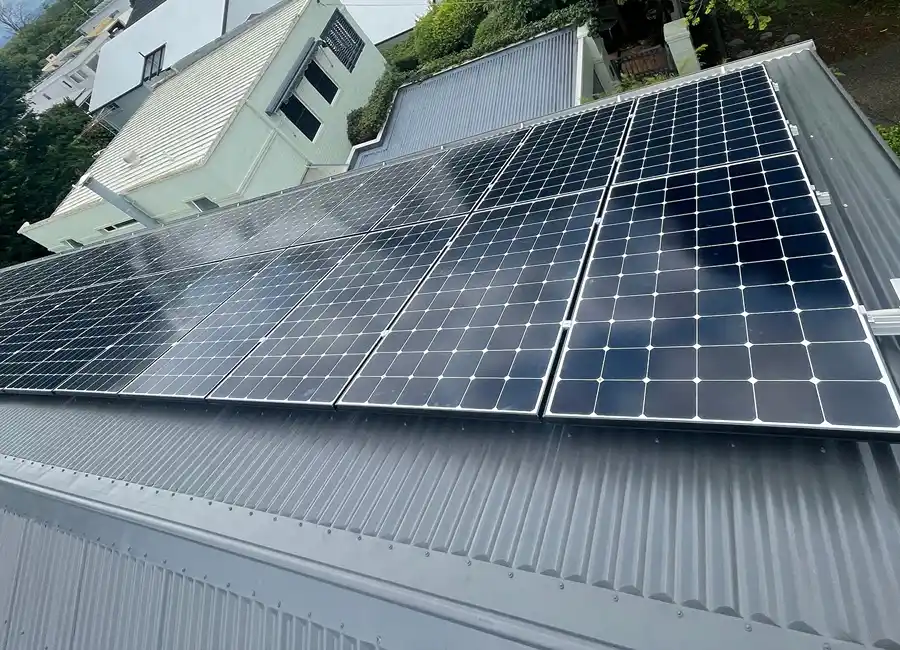 Solar panel system mounted on a residential metal roof capturing sunlight for energy.