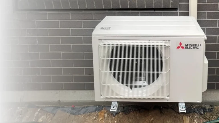 Mitsubishi Electric outdoor air conditioning condenser installed beside a residential home