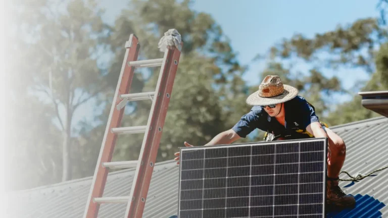Brix Electrical & Air technician positioning a solar panel during rooftop installation